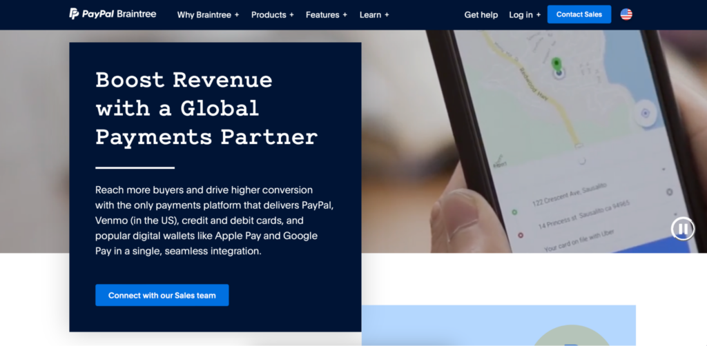 A preview of Paddle alternative Braintree by PayPal's homepage, with a large blue block with white text and an up-close image of someone holding a tablet.
