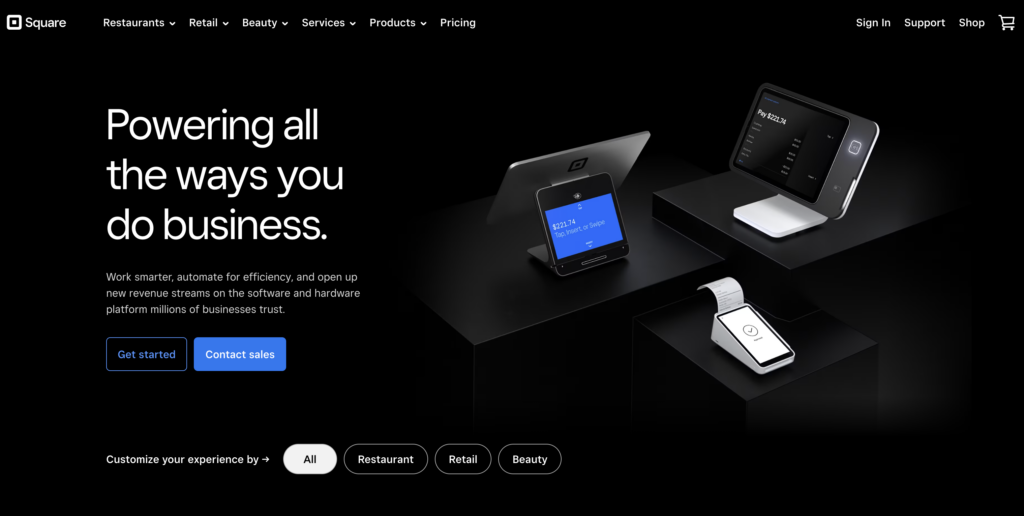 Screenshot of Stripe alternative Square's homepage, black with white text and blue buttons and photos of digital point of sale devices.