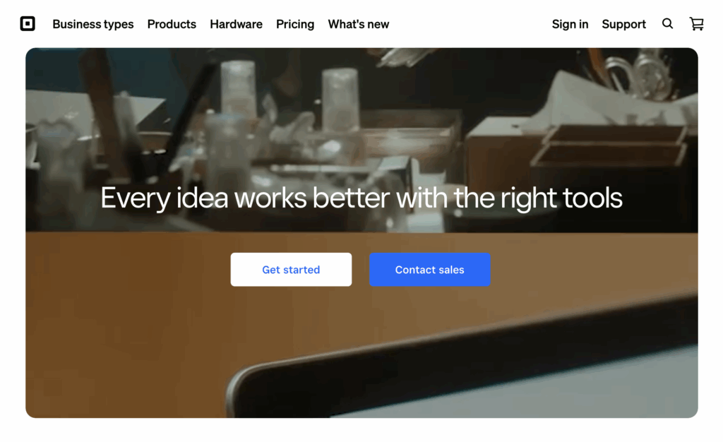 Screenshot of Square's homepage showing a video of business scenes in the background behind white and blue buttons.