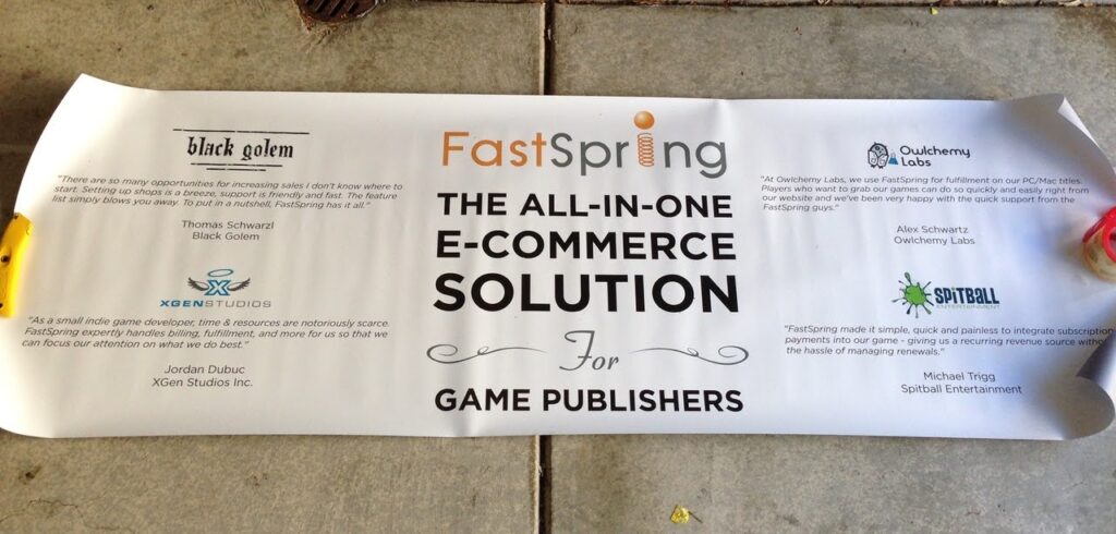 A photo of an old FastSpring trade show banner stating FastSpring is the all-in-one e-commerce solution for game publishers.
